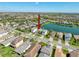 Aerial view of a home with a pond view, nestled in a desirable neighborhood with lush landscaping at 30423 Ceasar Park Dr, Wesley Chapel, FL 33543