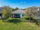 Home exterior with screen-in patio, beautiful lawn and fenced yard at 30423 Ceasar Park Dr, Wesley Chapel, FL 33543