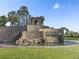 Stone entrance with fountain feature and professional landscaping welcomes you to The Ridge at Wiregrass Ranch at 30423 Ceasar Park Dr, Wesley Chapel, FL 33543