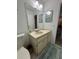 Bathroom that features a sink, a toilet, a cabinet, and neutral-colored tiles at 3120 Dole St, Holiday, FL 34691