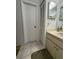 Bathroom that features a sink and cabinet, as well as, a closet and neutral-colored tiles at 3120 Dole St, Holiday, FL 34691