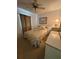Bedroom featuring a ceiling fan, window, bed, artwork, bedside table with lamp, and dresser at 3120 Dole St, Holiday, FL 34691