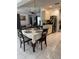 Dining area adjacent to the kitchen with tile flooring and views into the living room at 3120 Dole St, Holiday, FL 34691