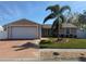 Charming single-story home with a well-manicured lawn and mature palm tree at 3120 Dole St, Holiday, FL 34691
