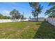 Large backyard with a well-maintained lawn and a white fence at 3249 Masonville Loop, Holiday, FL 34691