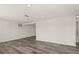 Spacious basement area featuring modern hardwood floors and ample lighting for a comfortable living space at 3249 Masonville Loop, Holiday, FL 34691