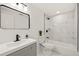 Updated bathroom featuring a modern vanity, black fixtures, and a shower-tub combination with marble-look tile at 3249 Masonville Loop, Holiday, FL 34691