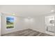 Bright bedroom with wood flooring and a view to an outdoor space at 3249 Masonville Loop, Holiday, FL 34691