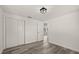 Bedroom with new laminate flooring, closet, and open doorway at 3249 Masonville Loop, Holiday, FL 34691