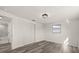 Bright bedroom with wood-look floors, closet, and ensuite bath at 3249 Masonville Loop, Holiday, FL 34691