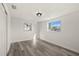 Bright bedroom with wood-look floors and dual windows at 3249 Masonville Loop, Holiday, FL 34691