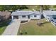 Aerial view of home with updated landscaping and hardscaped circular garden in front at 3249 Masonville Loop, Holiday, FL 34691