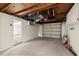 Spacious two-car garage with an open ceiling and a door leading to an interior living space at 3249 Masonville Loop, Holiday, FL 34691