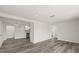Open-concept living room with hardwood floors and easy access to the kitchen and dining areas at 3249 Masonville Loop, Holiday, FL 34691