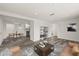 Open-concept living room with hardwood floors and easy access to the kitchen and dining areas at 3249 Masonville Loop, Holiday, FL 34691