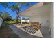 Covered outdoor patio with comfortable seating, a modern rug, and a peaceful backyard view at 3249 Masonville Loop, Holiday, FL 34691