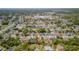 Aerial neighborhood view with a red location pin indicating the property, set amongst a tree-filled community at 3276 Morven Dr, Spring Hill, FL 34609