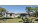 Spacious backyard featuring a screened-in porch and a grassy area surrounded by mature trees, offering a relaxing outdoor space at 3276 Morven Dr, Spring Hill, FL 34609