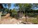 View of fenced backyard with a small storage shed and mature trees at 3276 Morven Dr, Spring Hill, FL 34609