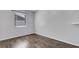 Minimalist bedroom featuring wood-look flooring, a window and ample natural light at 3276 Morven Dr, Spring Hill, FL 34609