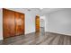 Bedroom with wood-look flooring, a ceiling fan, and a double-door closet at 3276 Morven Dr, Spring Hill, FL 34609