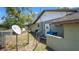 Exterior view of the side of the home, featuring a fenced yard and direct TV dish at 3276 Morven Dr, Spring Hill, FL 34609