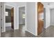 Hallway with views into the bathroom with gray tiling, and the bedroom with hard flooring at 3276 Morven Dr, Spring Hill, FL 34609