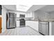 Bright kitchen with stainless steel appliances, white cabinetry and granite countertops at 3276 Morven Dr, Spring Hill, FL 34609