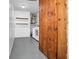 Functional laundry area with washer, dryer, water heater, wood cabinet and shelving at 3276 Morven Dr, Spring Hill, FL 34609