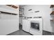 Bright laundry room with modern washer and dryer, shelving, and water heater at 3276 Morven Dr, Spring Hill, FL 34609