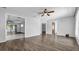 A bright living room features wood flooring, white walls, and seamless transition into adjacent rooms at 3276 Morven Dr, Spring Hill, FL 34609