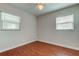 Well-lit bedroom featuring windows and gleaming hardwood floors at 337 Shore E Dr, Oldsmar, FL 34677