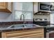 Kitchen with stainless steel sink and faucet, as well as appliances and a window view at 337 Shore E Dr, Oldsmar, FL 34677