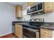 Modern kitchen with stainless steel range and microwave, and light wood cabinets at 337 Shore E Dr, Oldsmar, FL 34677