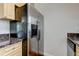 Modern stainless steel refrigerator against a neutral wall, alongside granite countertops at 337 Shore E Dr, Oldsmar, FL 34677