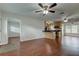 Bright living area with hardwood floors, ceiling fan, and an open layout to the kitchen at 337 Shore E Dr, Oldsmar, FL 34677