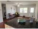 Open-concept living room with modern decor, natural light, and views into the adjacent bedroom at 337 Shore E Dr, Oldsmar, FL 34677