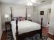 Comfortable main bedroom featuring a four-poster bed, soft rug, and ample natural light at 337 Shore E Dr, Oldsmar, FL 34677