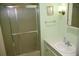 Well-lit bathroom featuring a shower and sink with storage at 369 Cobia Way, Oldsmar, FL 34677