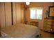 Charming bedroom with a large window, closet, and dresser with lamp at 369 Cobia Way, Oldsmar, FL 34677