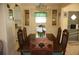 Traditional dining room boasts a wood table, seating for six, and a built-in buffet with glass-front cabinets at 369 Cobia Way, Oldsmar, FL 34677
