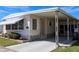 Well-maintained single-story home with a covered carport, awning, and charming landscaping, creating a comfortable and appealing exterior at 369 Cobia Way, Oldsmar, FL 34677