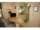 View of the bright breakfast bar and kitchen featuring a double sink, white cabinets, and plenty of countertop space at 369 Cobia Way, Oldsmar, FL 34677