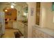 This kitchen offers ample storage with white cabinetry, a double sink, and an opening to another living area at 369 Cobia Way, Oldsmar, FL 34677