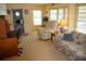 Bright and cozy living room featuring a work space, lots of seating, a fan, and ample natural light at 369 Cobia Way, Oldsmar, FL 34677