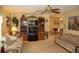 Comfortable living room with a ceiling fan, patterned sofas, and a wooden entertainment center, creating a cozy and inviting atmosphere at 369 Cobia Way, Oldsmar, FL 34677