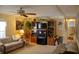 Cozy living room with a ceiling fan, comfortable sofas, and a wooden entertainment center, perfect for relaxing and entertaining at 369 Cobia Way, Oldsmar, FL 34677