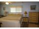 Cozy primary bedroom with light blue walls, a queen bed, and lots of dresser space for storage at 369 Cobia Way, Oldsmar, FL 34677