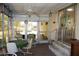 Relaxing sunroom with a ceiling fan, dining set, and lots of windows at 369 Cobia Way, Oldsmar, FL 34677