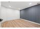 Unfurnished basement room with wood flooring, white walls, and contemporary design at 398 Walnut Ct, Palm Harbor, FL 34683